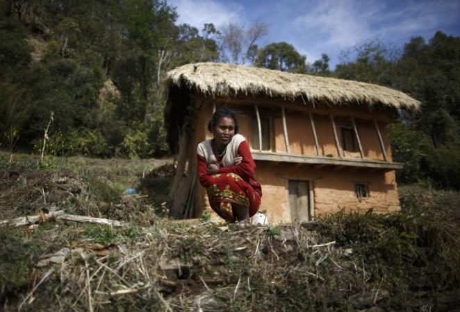 A woman sits outside her house while practicing Chaupadi in Western Nepal Nepal menstruation