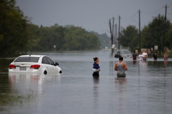 Residents wade through flood waters from Tropical Storm Harvey in Houston, Texas, U.S. Tropical storm Harvey