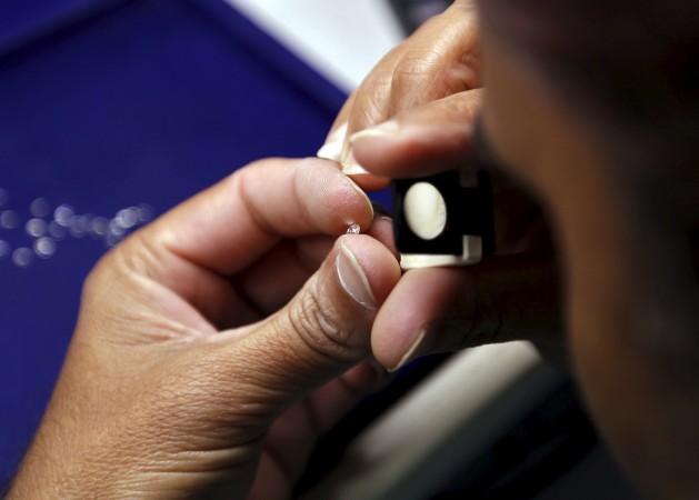 A craftsman checks the shape of a diamond at the polishing department of a diamond processing unit at Surat in Gujarat. REUTERS/Amit Dave Diamond polishing