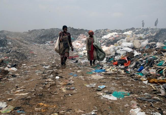 A scavenger carries recyclable plastic materials packed in a sack at the Dandora dumping site on the outskirts of Nairobi, Kenya Kenya bans plastic bags