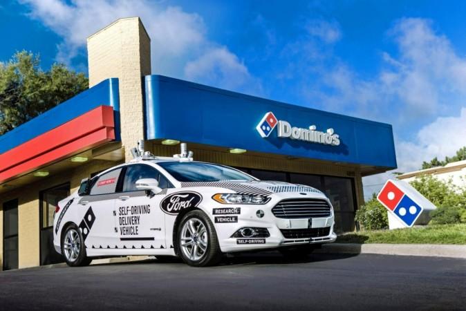 A Ford self-driving delivery vehicle is pictured in front of a Domino's pizza restaurant A Ford self-driving delivery vehicle is pictured in front of a Domino's pizza restaurant