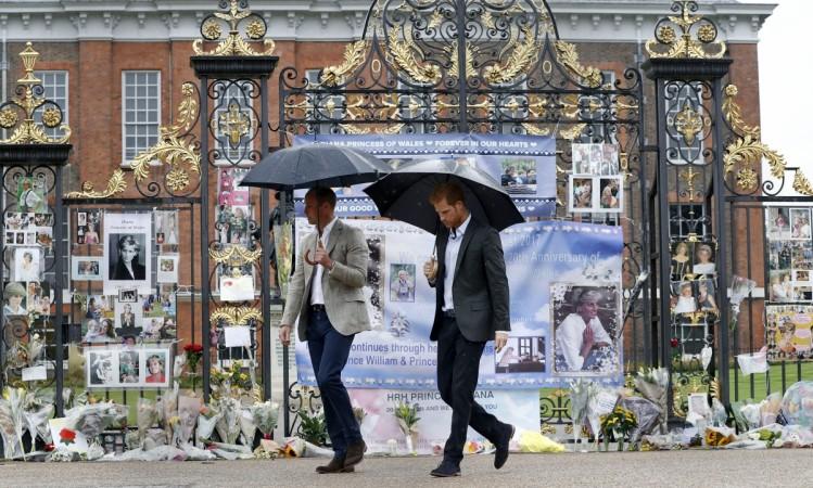 Prince William, Duke of Cambridge and Britain's Prince Harry walk away after looking at tributes left by members of the public at one of the entrances of Kensington Palace to mark the coming 20th anniversary of the death of Diana, Princess of Wales, in London on August 30, 2017. Princess Diana death anniversary, Prince William, Prince Charles