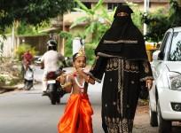 A Muslim woman dresses up her kids for Janmashtami festival in India