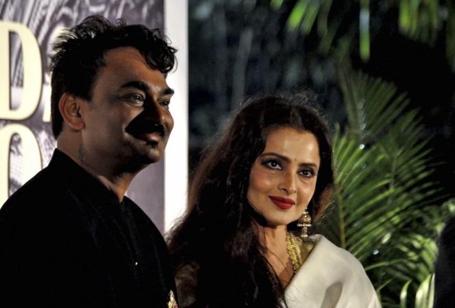 Indian Bollywood actress Rekha (R) and designer Wendell Rodricks attend the 'Mada Goa' book launch in Mumbai on February 3, 2012. Wendell Rodricks