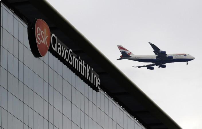 A British Airways airplane flies past a signage of pharmaceutical giant GlaxoSmithKline (GSK) in London in this file photo. GlaxoSmithKline is said to have formed a separate team to chalk out aggressive acquisition plans to further its growth in the competitive Indian market. REUTERS/Luke MacGregor GlaxoSmithKline