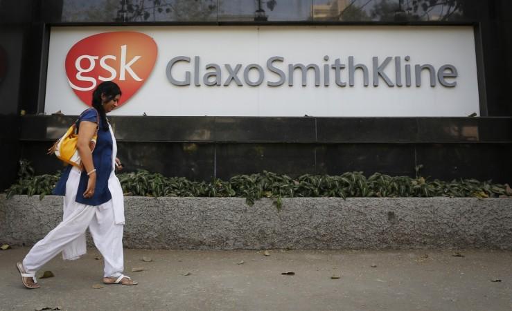 A woman walks past a GlaxoSmithKline Pharmaceuticals Ltd logo outside the company headquarters in Mumbai in this December 16, 2013 file photo. REUTERS/Danish Siddiqui GlaxoSmithKline