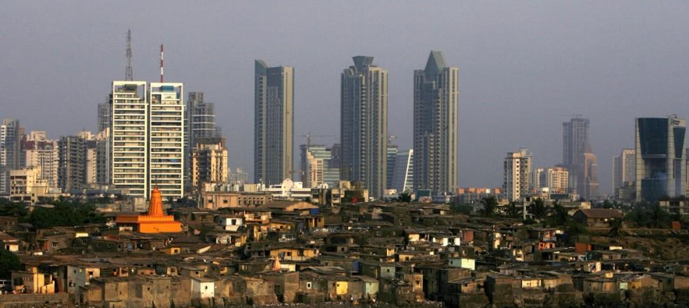 High rise buildings are seen behind a slum in Mumbai April 28, 2009. REUTERS/Arko Datta (INDIA SOCIETY BUSINESS) Inequality