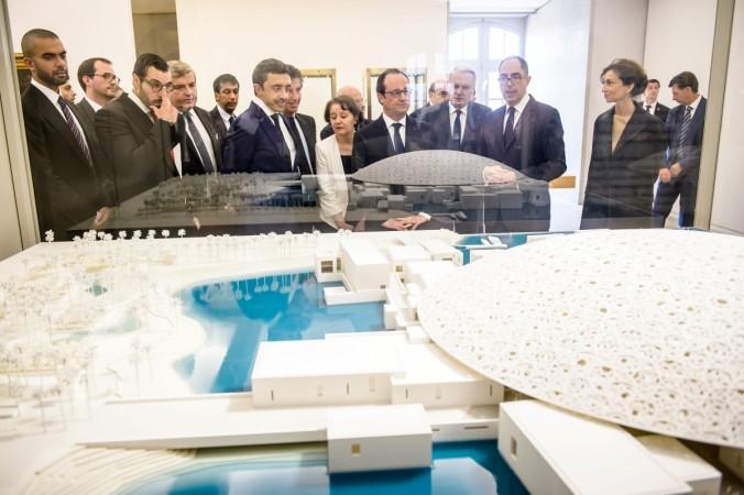 French President Francois Hollande (C) and United Arab Emirates Minister of Foreign Affairs Sheikh Abdullah bin Zayed Al Nahyan (4thL) look a scale model of the Louvre Abu Dhabi project during a visit at the Louvre museum in Paris, France. Viewing the model of the Louvre Abu Dhabi project