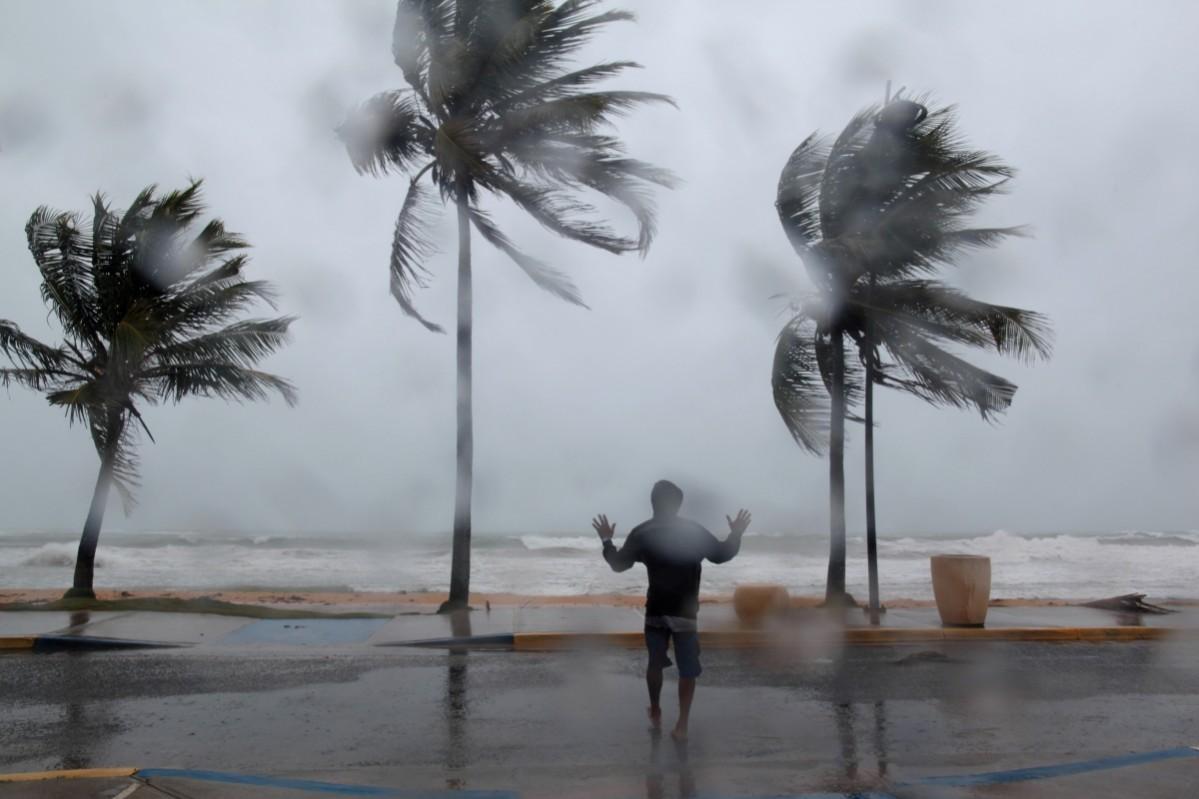 A man reacts in the winds and rain as Hurricane Irma slammed across islands in the northern Caribbean Hurricane Irma
