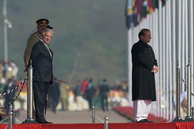 Pakistan's Prime Minister Nawaz Sharif (R) and Defence Minister Khawaja Asif (L) wait for the arrival of President Mamnoon Hussain during a Pakistan Day military parade in Islamabad on March 23, 2017. Khawaja Asif