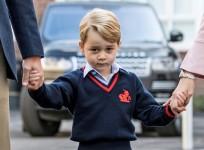 Prince George holds his father Britain's Prince William's hand as he arrives on his first day of school at Thomas's school in Battersea, London.