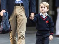 Prince George holds his father Britain's Prince William's hand as he arrives on his first day of school at Thomas's school in Battersea, London
