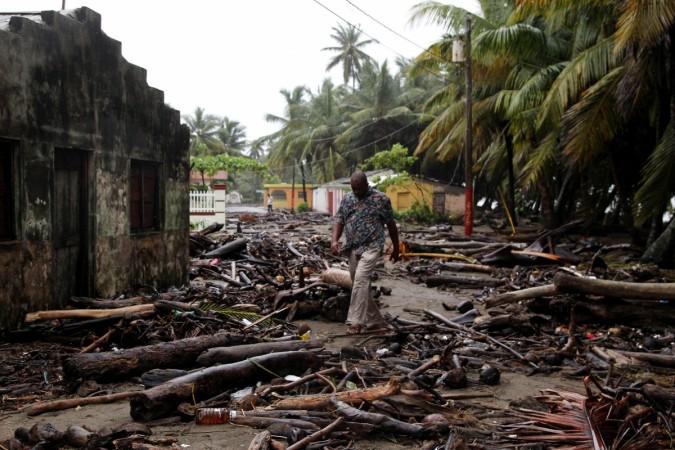 A man walks among debris as Hurricane Irma moves off the northern coast of the Dominican Republic Irma