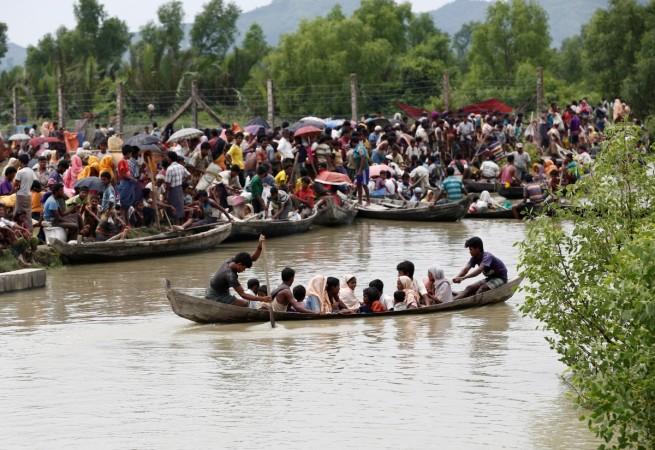 A boat carrying Rohingya refugees is seen leaving Myanmar through Naf river while thousands other waiting in Maungdaw, Myanmar Rohingya