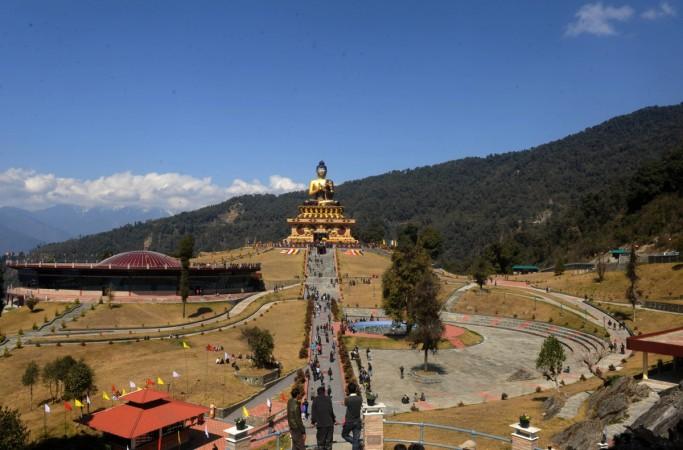 Visitors walk at the 130 foot Lord Buddha statue during the Dzung ceremony and curtain raiser to unveil the Buddha Park at Rabong in South Sikkim Sikkim