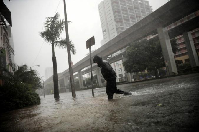 A local resident walks across a flooded street in downtown Miami as Hurricane Irma arrives at south Florida Florida