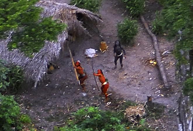 Members of an uncontacted Amazon Basin tribe and their dwellings are seen during a flight over the Brazilian state of Acre Amazon tribe