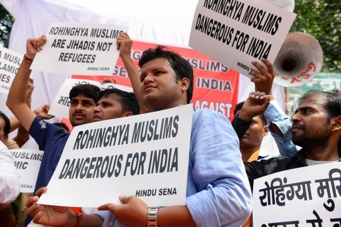 Indian activists from the right-wing organization Hindu Sena hold placards as they shout slogans against Rohingya Muslim refugees being granted asylum in India, in New Delhi on September 11, 2017. Rohingya Muslims India