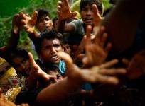 Rohingya refugees stretch their hands for food near Balukhali in Cox's Bazar, Bangladesh.