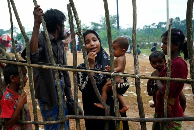 A new Rohingya refugee woman cries as they arrive near the Kutupalang makeshift Refugee Camp, in Cox's Bazar, Bangladesh. A new Rohingya refugee woman cries as they arrive near the Kutupalang makeshift Refugee Camp, in Cox's Bazar, Bangladesh.