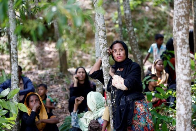 A Rohingya woman looks on after being restricted by the members of Border Guards Bangladesh (BGB) to enter into Bangladesh side, in Cox's Bazar, Bangladesh. A Rohingya woman looks on after being restricted by the members of Border Guards Bangladesh (BGB) to enter into Bangladesh side, in Cox's Bazar, Bangladesh.
