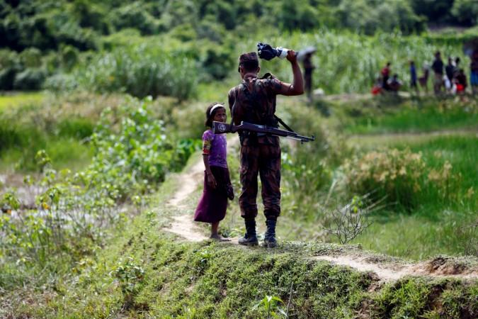 A member of Border Guard Bangladesh (BGB) tells a Rohingya girl not to come on Bangladesh side, in Cox's Bazar, Bangladesh A member of Border Guard Bangladesh (BGB) tells a Rohingya girl not to come on Bangladesh side, in Cox's Bazar, Bangladesh