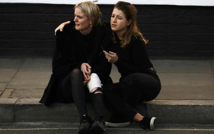 An injured woman outside Parsons Green station train explosion London