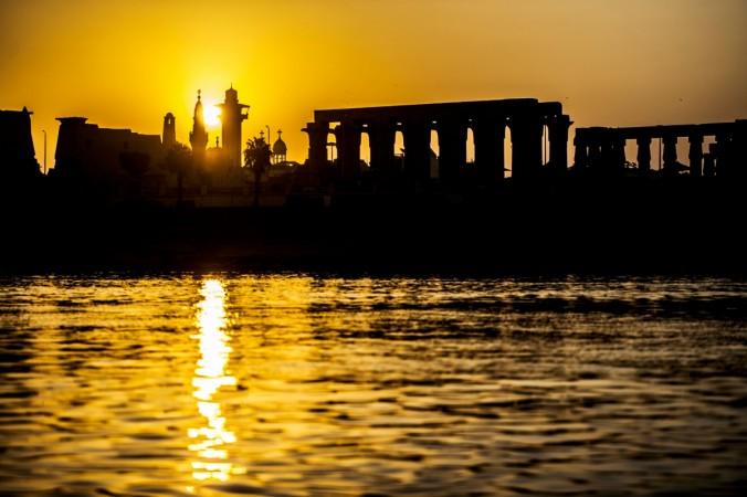 A picture taken on September 10, 2017 shows a silhouette of the skyline of the southern Egyptian city of Luxor at sunrise, showing the pylons and columns of the ancient Egyptian Temple of Luxor and the minaret of the 13th century Abu Haggag mosque, with the belltowers of the Coptic Orthodox Church of the Archangel Michael appearing in the background. Luxor Temple, Egypt