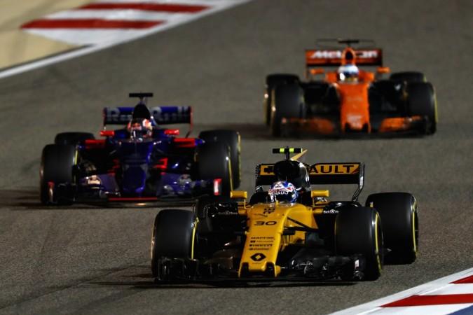 Jolyon Palmer of Great Britain driving the (30) Renault Sport Formula One Team Renault RS17 leads Daniil Kvyat of Russia driving the (26) Scuderia Toro Rosso STR12 and Fernando Alonso of Spain driving the (14) McLaren Honda Formula 1 Team McLaren MCL32 on track during the Bahrain Formula One Grand Prix at Bahrain International Circuit on April 16, 2017 in Bahrain f1, formula 1