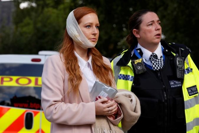 An injured woman is led away after a blast at Parsons Green underground station in London. London