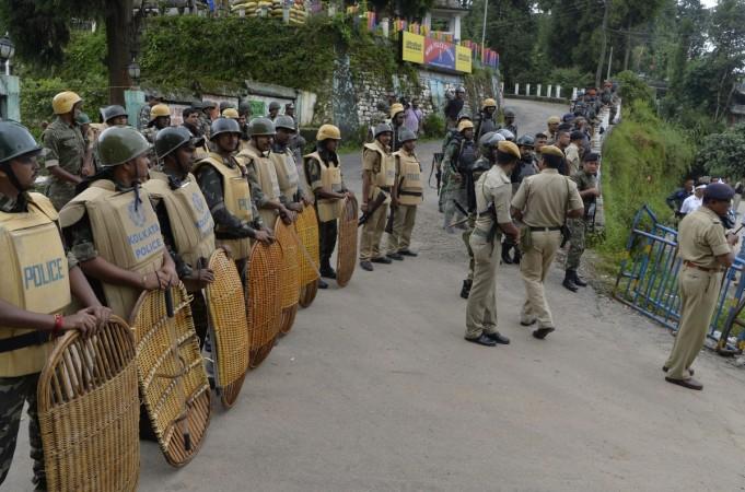 security personnel stand guard as supporters of the Trinamul Congress along with local residents of Mirik take part in a rally urging a return to normal life Darjeeling