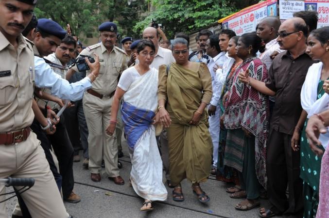 Bhartiya Janta Party (BJP) MLA and former minister in the Narendra Modi state government, Maya Kodnani (CL) is escorted by police on her arrival at special court in Ahmedabad on August 31, 2012. Maya Kodnani