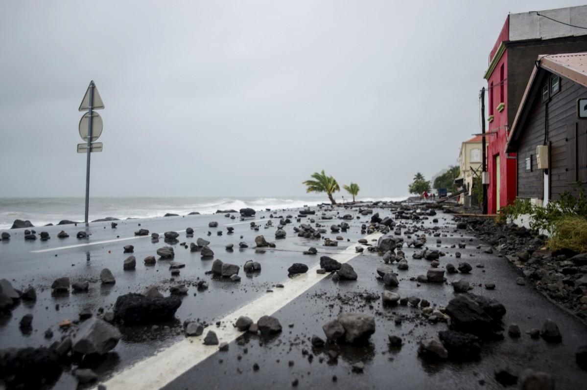 A picture shows rocks swept by strong waves onto a road in Le Carbet, on the French Caribbean island of Martinique Hurricane Maria