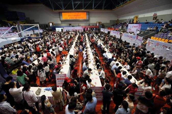 This photo taken on May 29, 2016 shows people chatting during a matchmaking event in Hangzhou, eastern China's Zhejiang province. The event held in Zhejiang University attracted more than 20,000 single people. China blind date