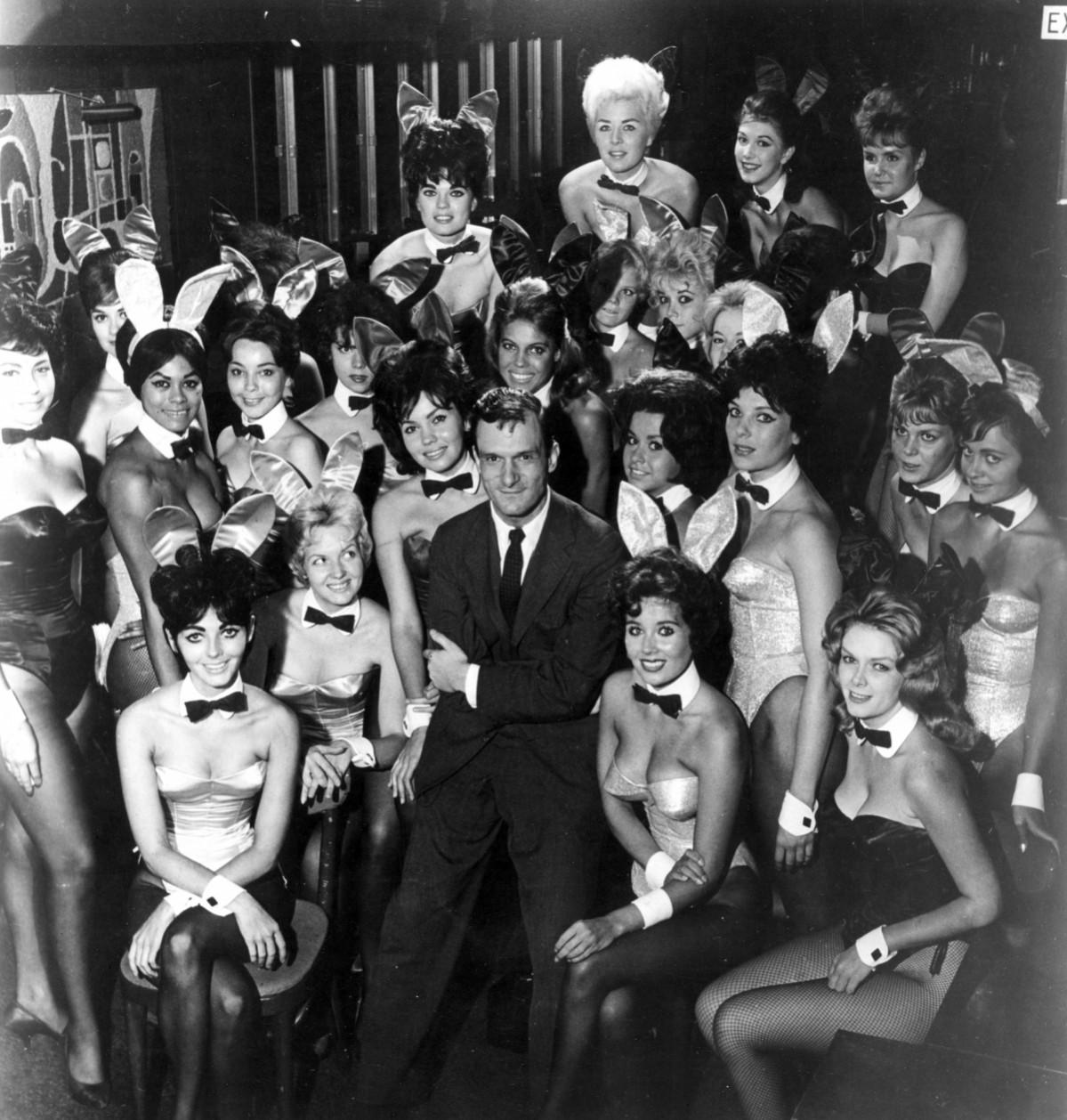 Millionaire publisher of Playboy magazine Hugh Hefner poses with a bevy of bunny girls at one of America's chain of Playboy clubs. Hugh Hefner