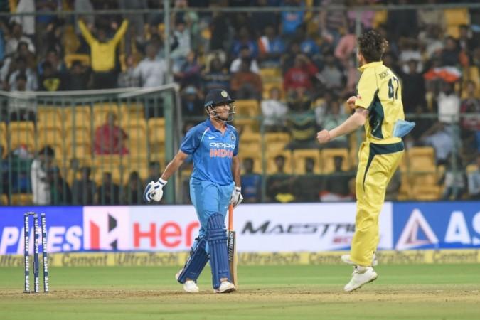 Kane Richardson (right) celebrates dismissing MS Dhoni in the 4th ODI in Bengaluru. MS Dhoni