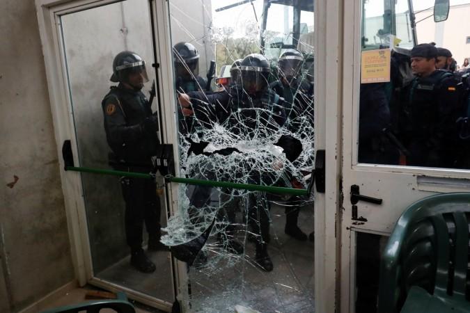 In picture: Spanish Civil Guard officers break through a door at a polling station for the banned independence referendum where Catalan President Carles Puigdemont was supposed to vote in Sant Julia de Ramis, Spain October 1, 2017. Catalonia independence referendum