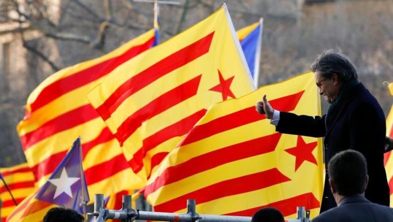 Former Catalan President Artur Mas gives a thumbs up to a crowd of people waving Catalan Estelada flags as he arrived to court in Barcelona Catalonia