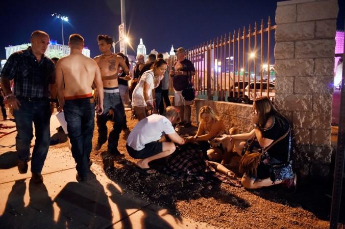 eople tend to the wounded outside the Route 91 Harvest Country music festival grounds after an apparent shooting on October 1, 2017 in Las Vegas, Nevada. Las Vegas shooting