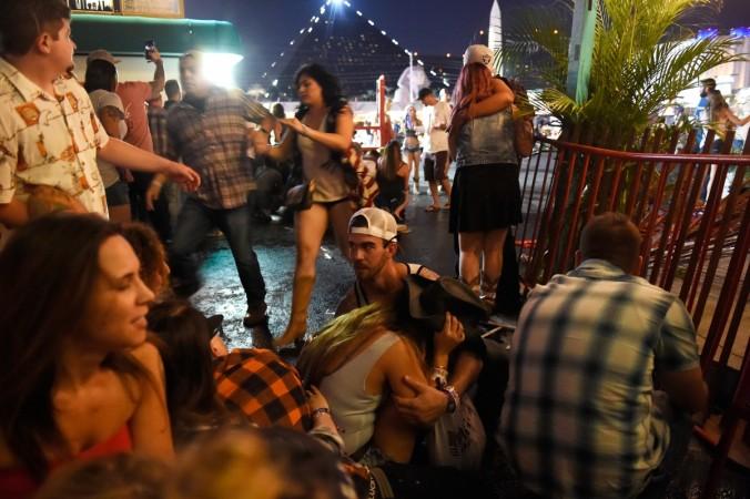 People run for cover at the Route 91 Harvest country music festival after apparent gun fire was heard on October 1, 2017 in Las Vegas, Nevada. There are reports of an active shooter around the Mandalay Bay Resort and Casino. Las Vegas shooting