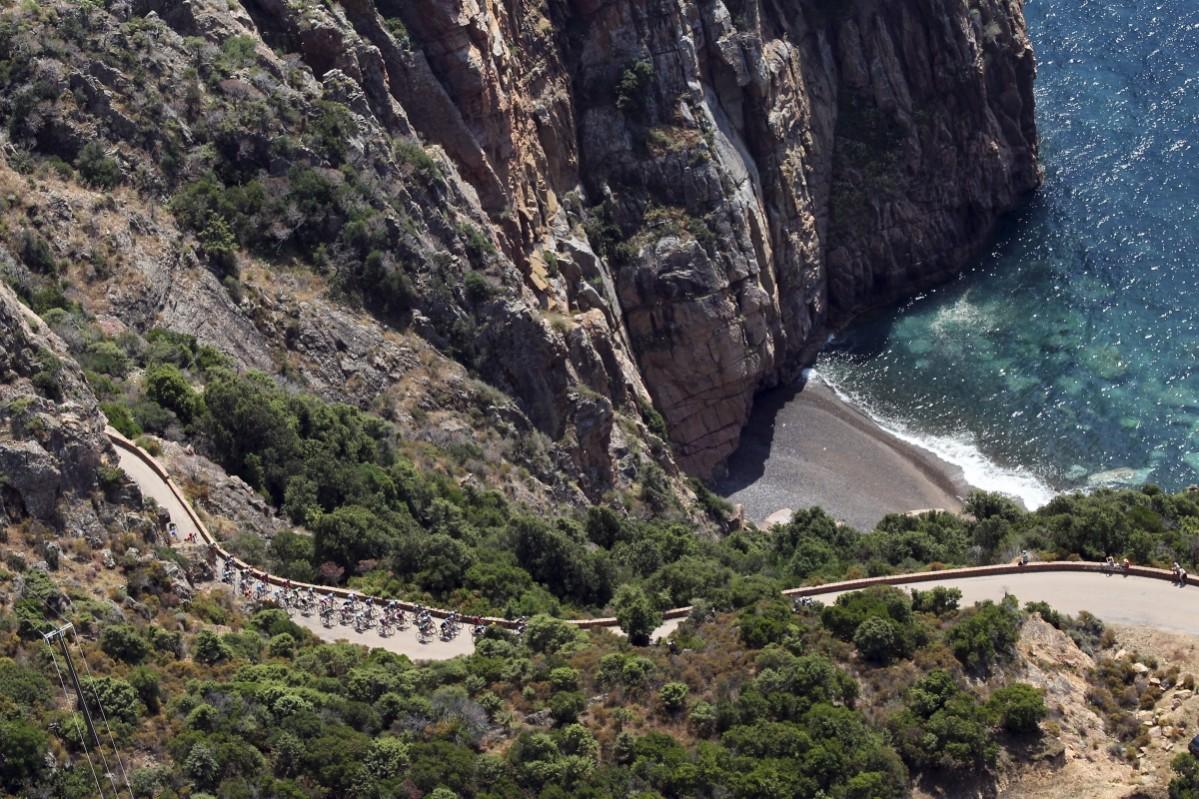 An aerial view shows the pack of riders as they cycle along the coast during the 145.5 km third stage of the centenary Tour de France cycling race from Ajaccio to Calvi, on the French Mediterranean island of Corsica July 1, 2013. Ajaccio