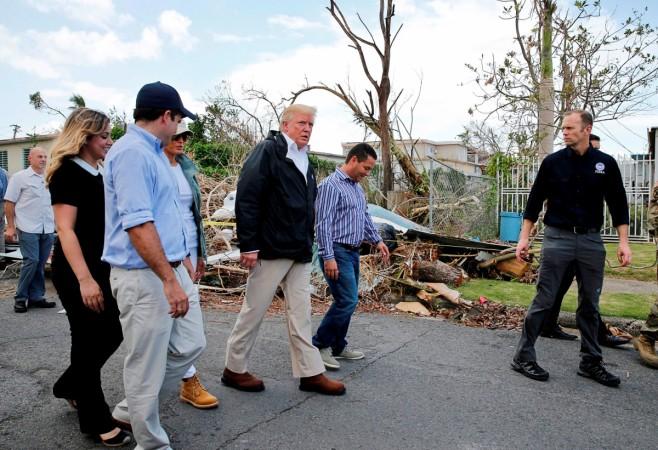 U.S. President Donald Trump walks past hurricane wreckage in Puerto Rico Donald Trump