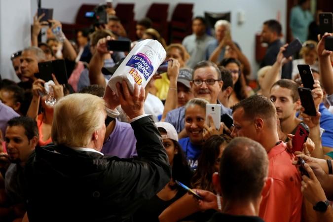 Donald Trump tosses rolls of paper towels to people at a hurricane relief distribution center at Calvary Chapel in San Juan, Puerto Rico. Donald Trump