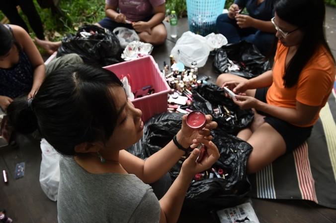 Female ex-inmates and volunteers recycle donated lipstick in Bangkok using food colouring from the kitchen and vaseline to create a homemade gloss. petroleum jelly use