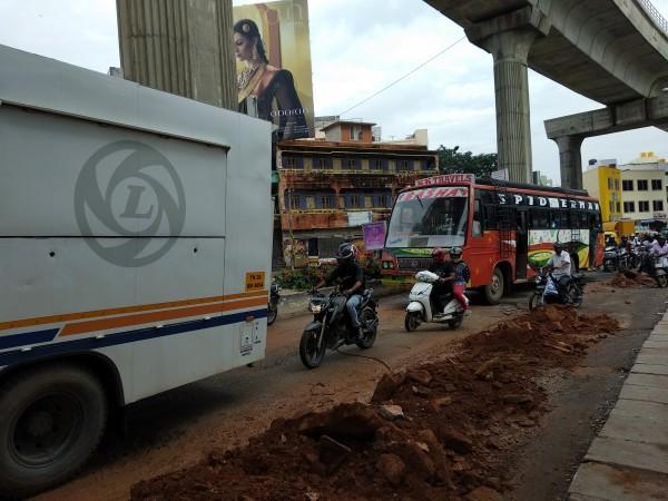 People struggle due to potholes near Halasuru Metro Station in Bangalore Potholes, Bangalore potholes