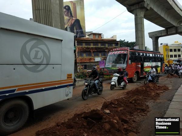 People struggling to ride travel due to potholes near Halasuru Metro Station in Bangalore Potholes, Bangalore potholes