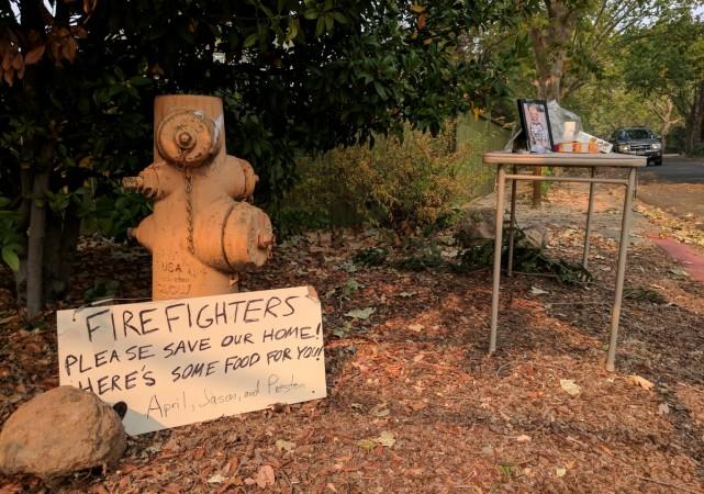 In picture: A sign left by an evacuated resident, fleeing wildfires in the heart of the California's wine country, rests against a fire hydrant in the evacuated town of Calistoga, California, US, October 12, 2017. California wildfires
