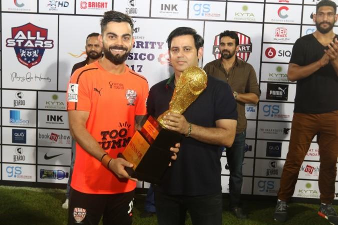 Virat Kohli receives the winner's trophy. Virat Kohli