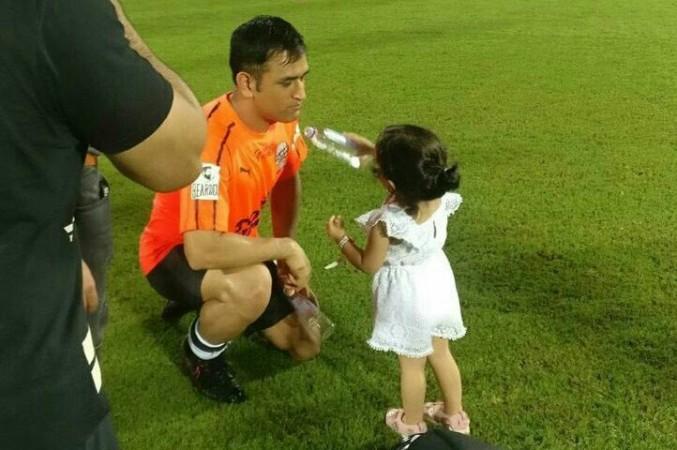 Ziva gives water to dad Dhoni during Celebrity Clasico match in Mumbai. MS Dhoni