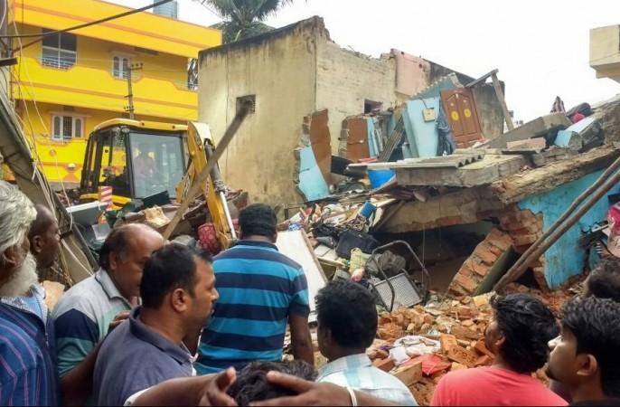 In picture: People gather around a building that collapsed in the Ejipura area of Bengaluru on Monday, October 13, 2017. Bengaluru building collapse